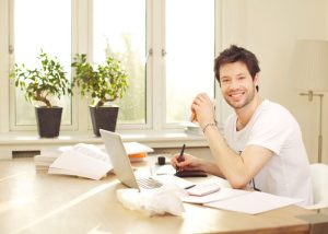 Confident Smiling Man Working At Desk