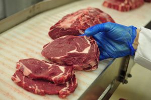 An employee selects cuts of Irish rib-eye beef steak as they work on the packaging line at ABP Foods Group's meat processing plant in Cahir, Ireland, on Wednesday, Jan. 14, 2015. The U.S., the world's biggest beef consumer, is lifting a ban on imports from Ireland more than 15 years after mad cow disease spurred restrictions of supplies from Europe. Photographer: Aidan Crawley/Bloomberg
